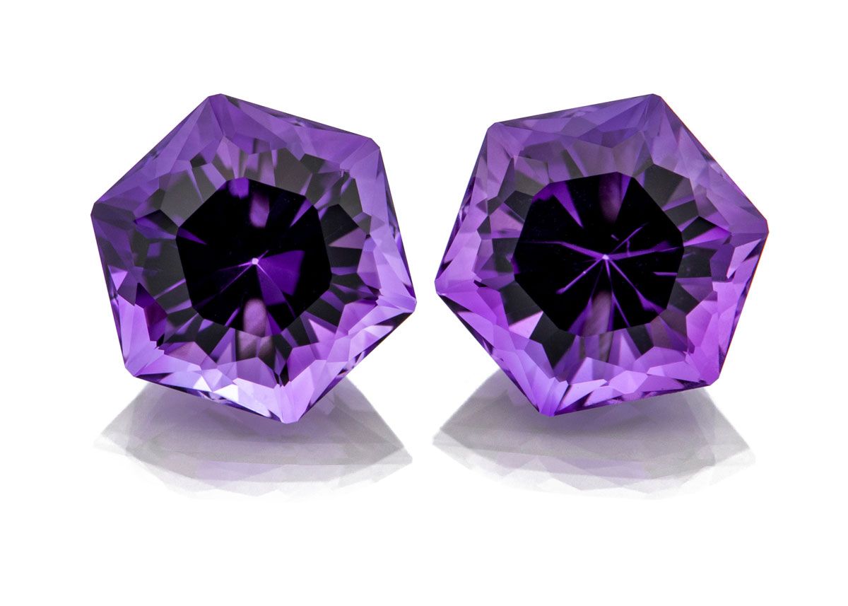 A pair of vibrant purple hexagon shaped Amethyst