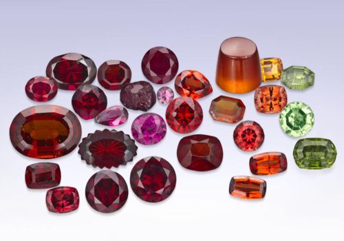 a collection of colorful red, pink, orange, yellow, green, and purple garnets