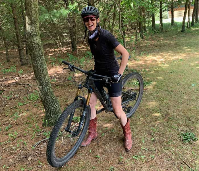 Ellie Thompson on her bike in the woods during a cross training competition